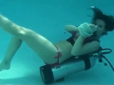 Scuba woman tied to pool ladder