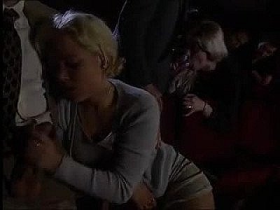 Orgy sex in a dark theater